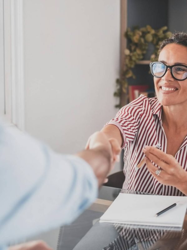 smiling-caucasian-female-hr-manager-handshake-hire-male-candidate-at-job-interview.jpg